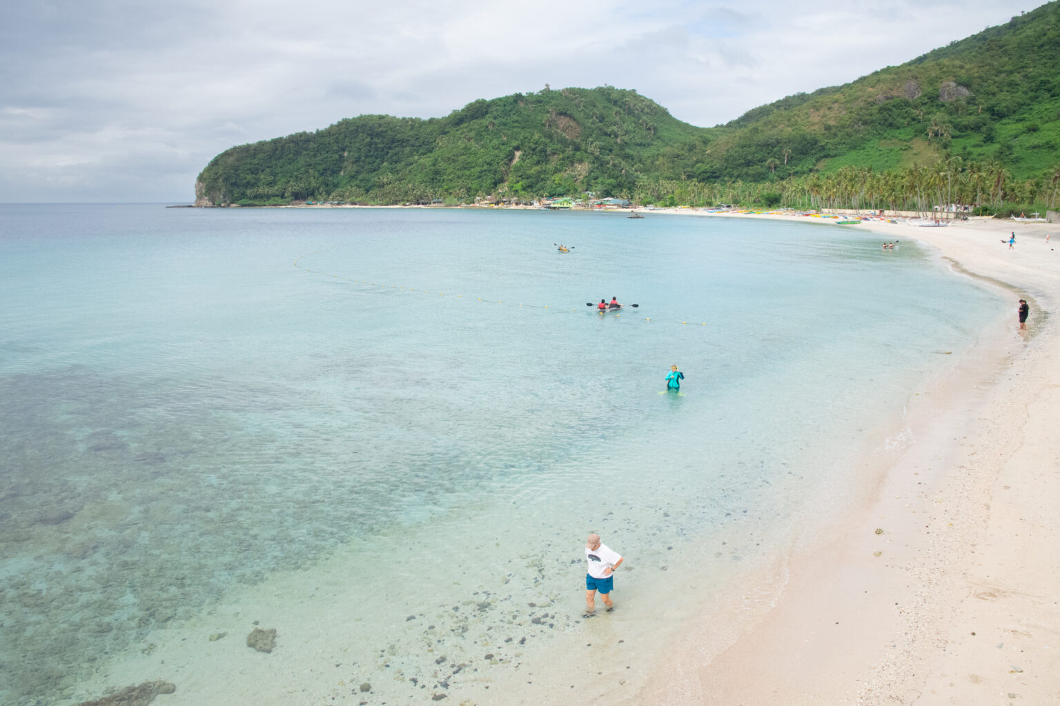 People swim in ocean, seen from above