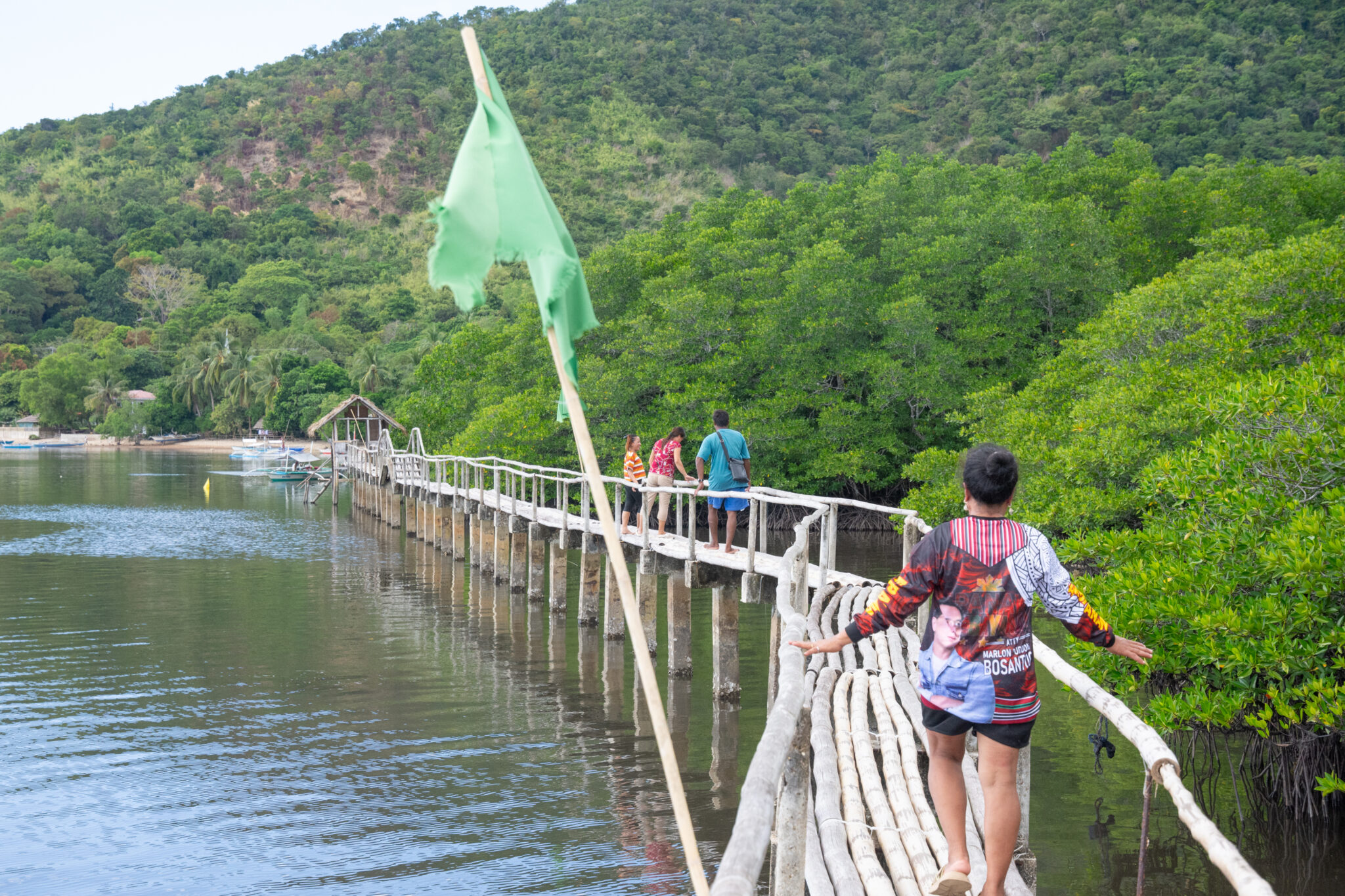 People walk on bamboo section of boardwalk