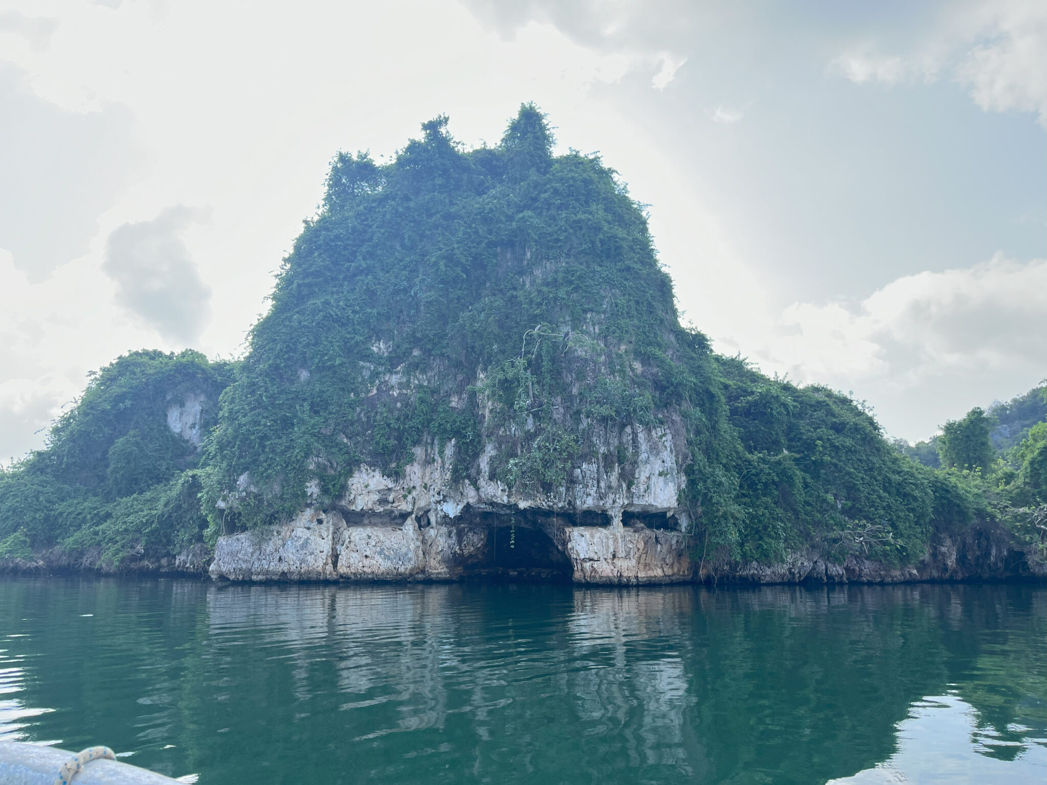 Limestone cave entrance above water