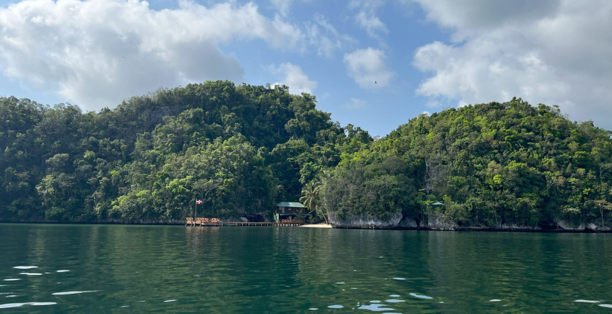 San Lorenzo Bay water with green hills and mangroves