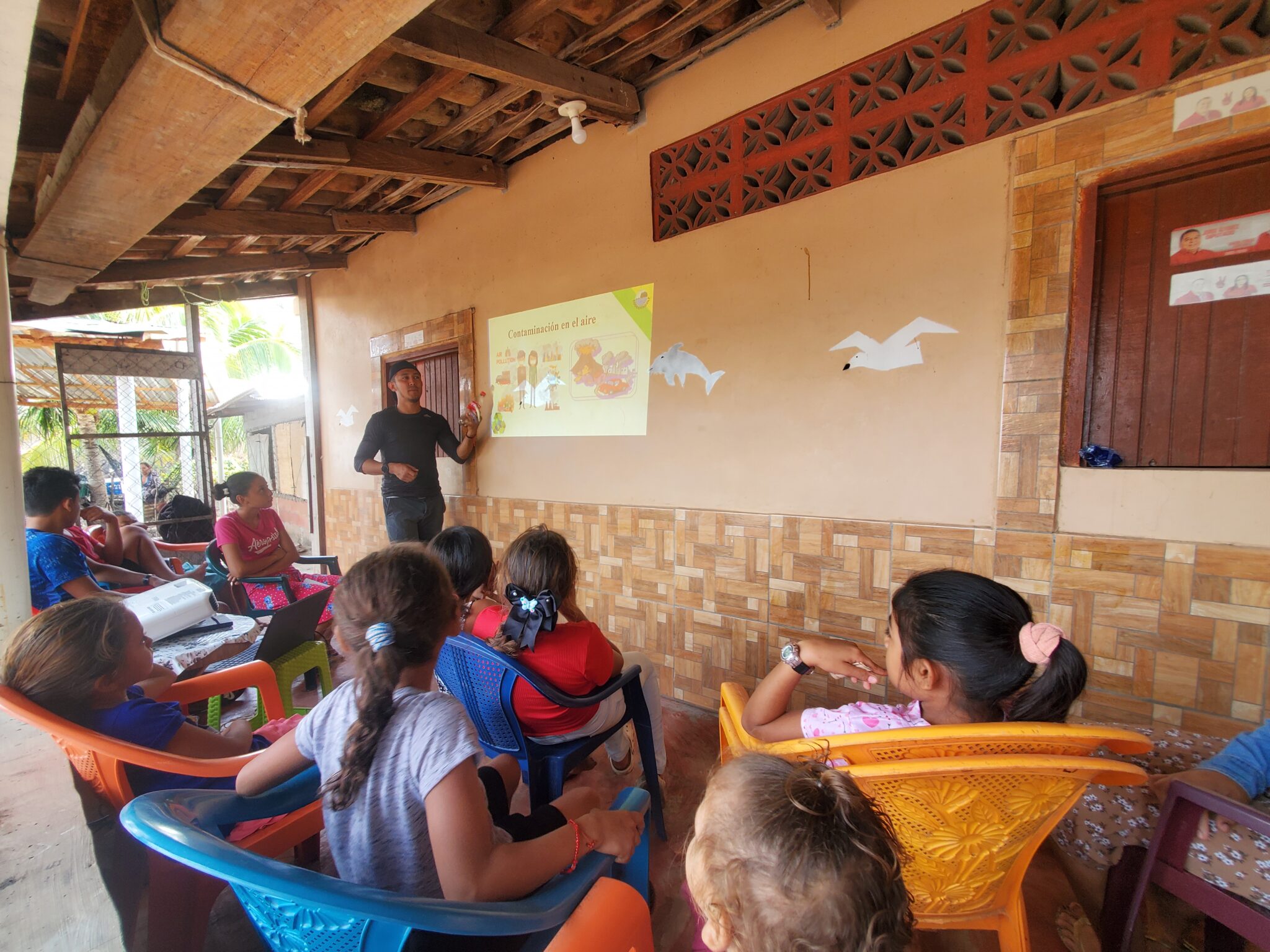 Kids watch a presentation in an outdoor classroom