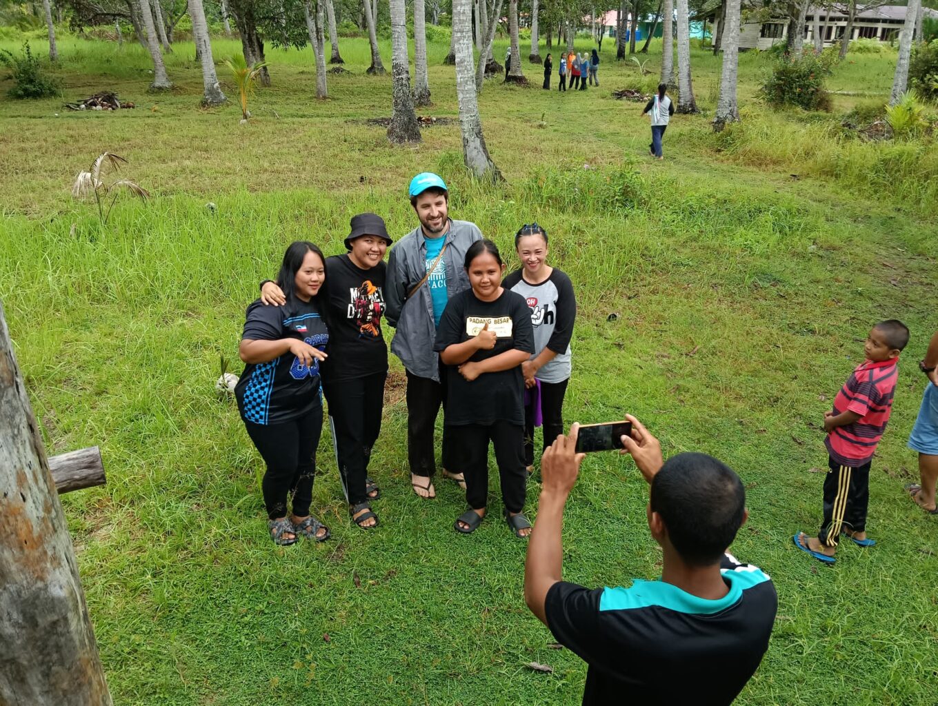 Group poses for a photo outdoors