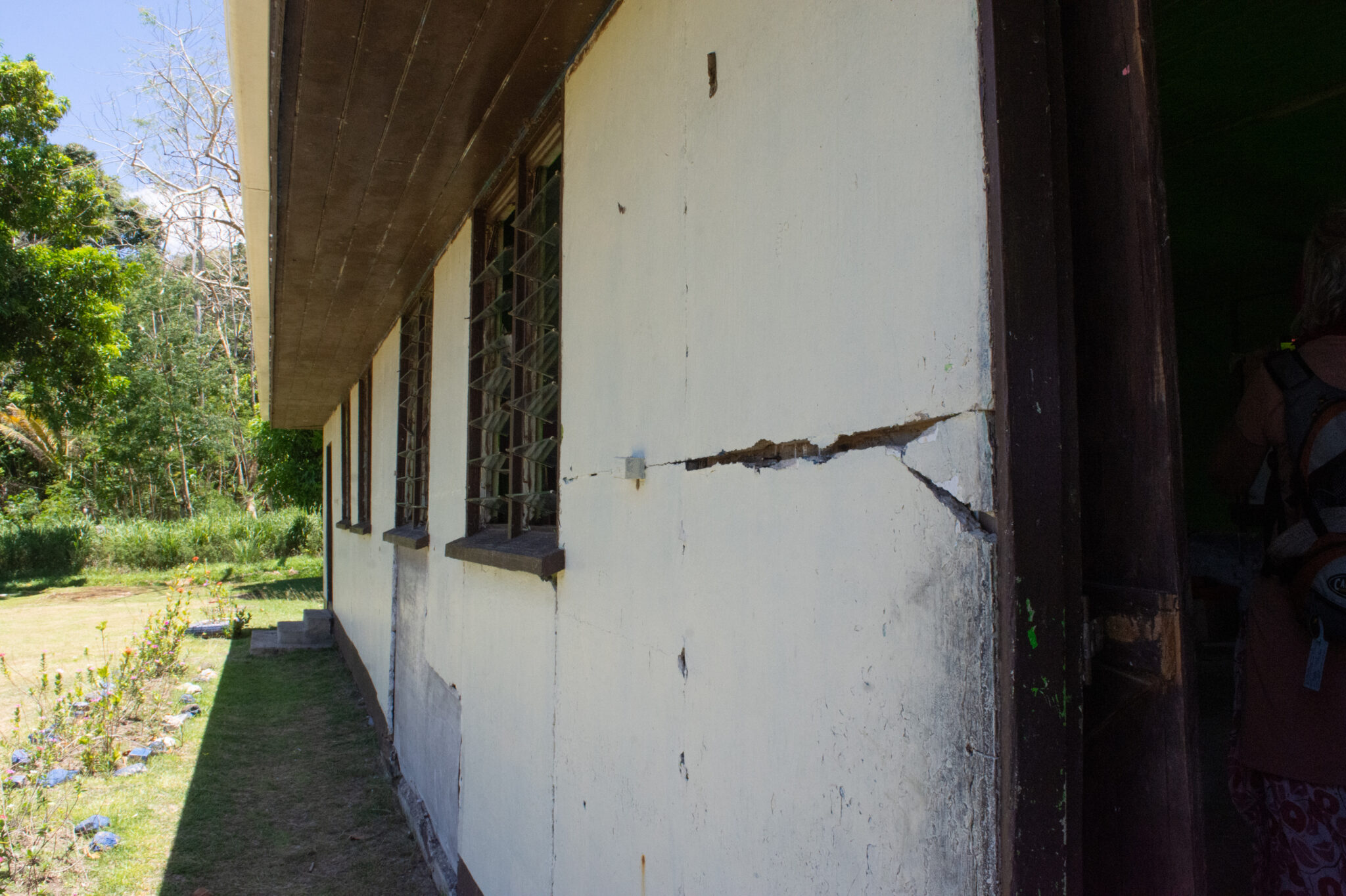 Exterior of old building showing cracks and other damage